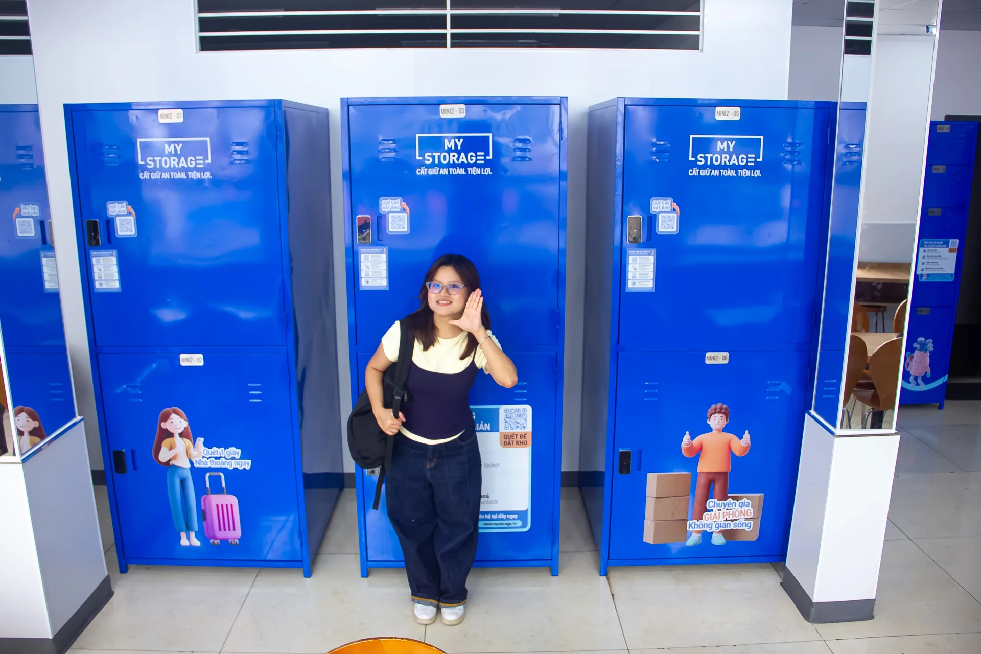 A customer with a backpack standing beside the MyStorage lockers at Ministop Tran Khac Chan
