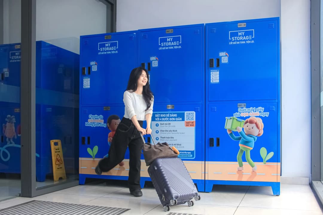 A customer pulling a suitcase past the MyStorage lockers at Centre Mall District 6