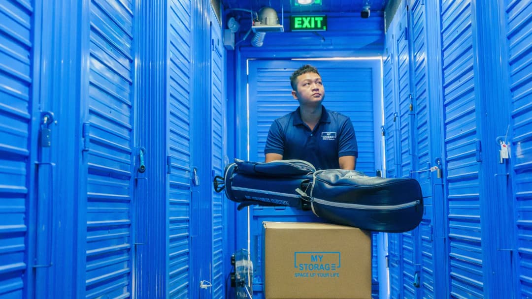A man handling stored items in the air-conditioned warehouse