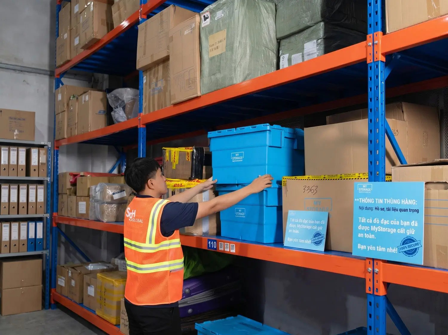 A warehouse worker handling storage boxes