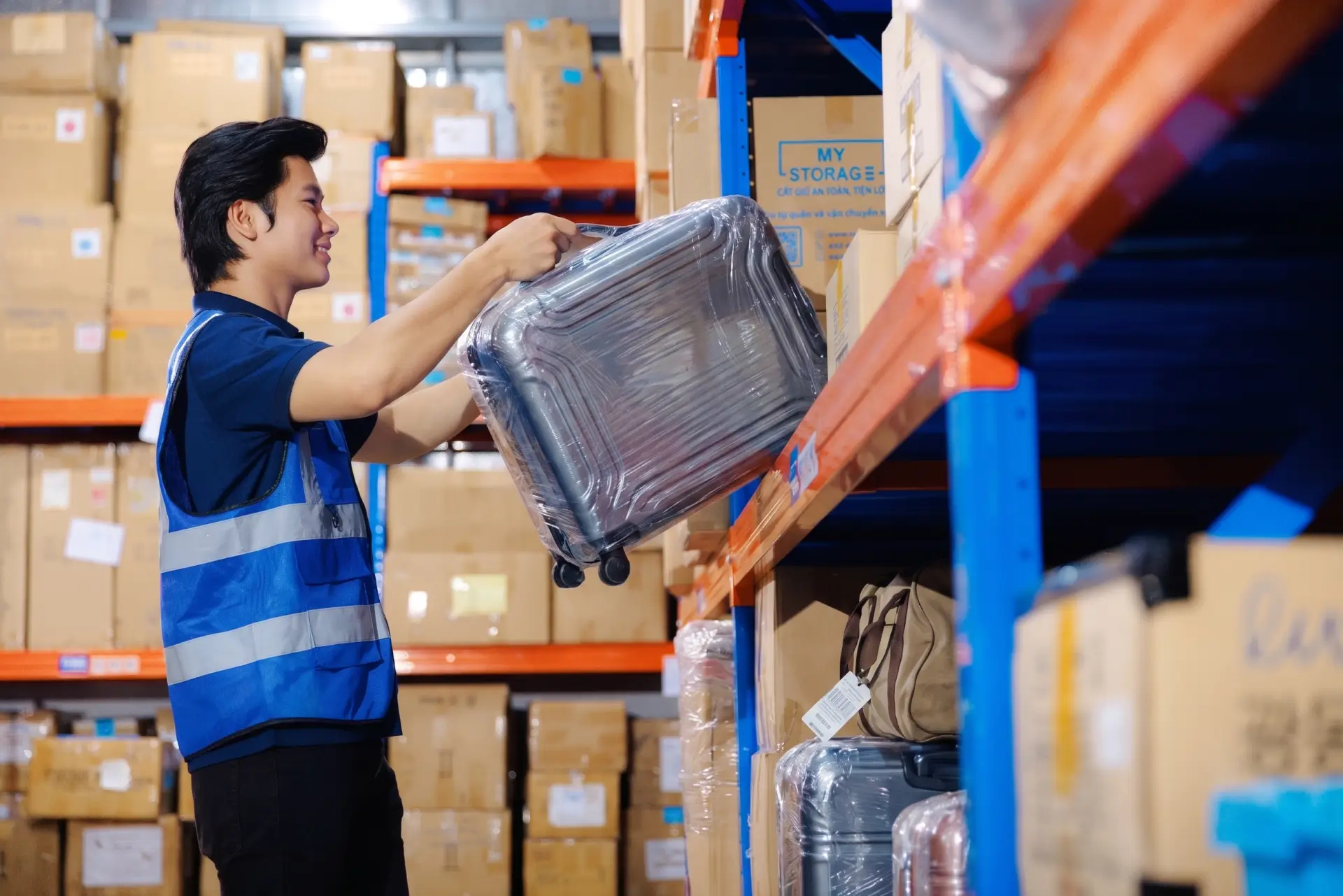 MyStorage warehouse staff handling stored luggage in the full service warehouse