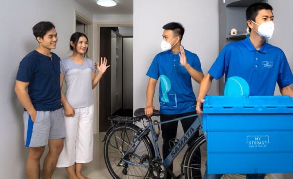 MyStorage staff collecting a customer's bicycle and storage box from their apartment